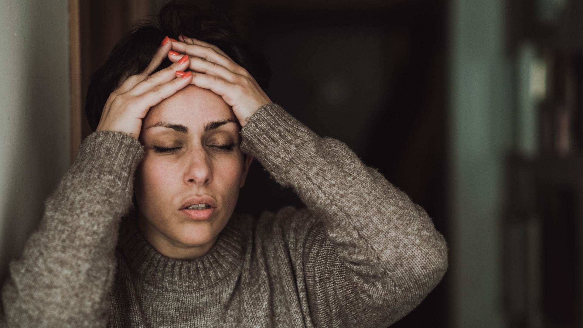 Woman holding her head in frustration